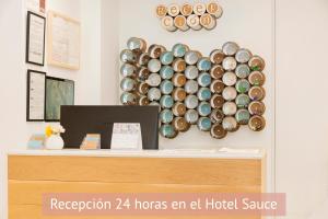 a wall with a bunch of plates on a shelf at Apartamentos Sabinas Don Jaime in Zaragoza