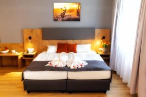 Postel nebo postele na pokoji v ubytování Hotel La Mirabelle close to Europa Park
