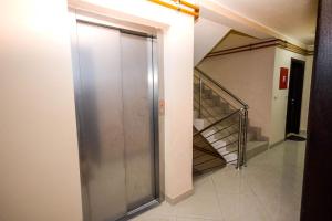 a metal elevator in a hallway with a staircase at Centar in Vrnjačka Banja