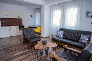 a living room with a couch and chairs and a table at Villa Clock Tower - Саат Кула in Ohrid