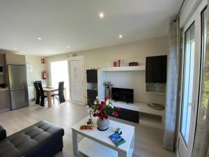 a living room with a couch and a table at Apartamentos La Ardina Celorio in Celorio