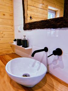 a bathroom with a white sink in a room at Domki u Danki in Brenna