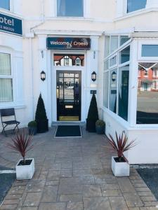 a door to a store with plants in front of it at Oak Alyn Hotel in Llandudno