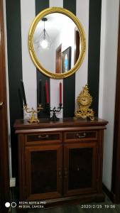 a wooden dresser with a mirror on top of it at Casa de la Abuela en el Camino de Santiago a Finiesterre in Negreira