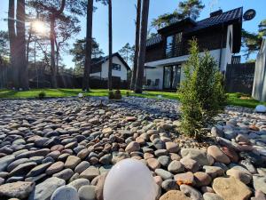 a rock garden in front of a house at Villa Kris in Pobierowo