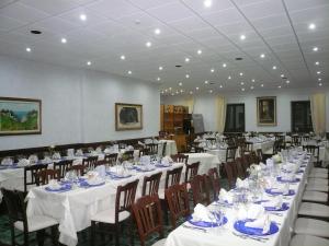 a large banquet hall with white tables and chairs at Albergo Belvedere in Scanno