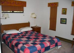 a bedroom with a bed with a checkered blanket at Birch Creek #8 - 2BR/1.5BA in June Lake