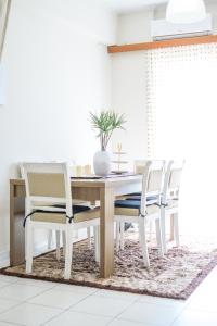 a dining room with a wooden table and chairs at Luxury House in Vrachati