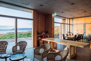 a dining room with a large wooden table and chairs at Drangar Country Guesthouse in Drangar
