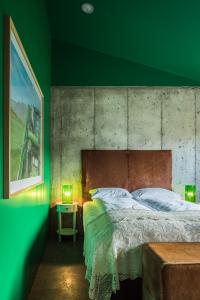 a bedroom with a large bed with a green wall at Drangar Country Guesthouse in Drangar