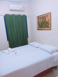 Uma cama ou camas num quarto em Hotel Ypê