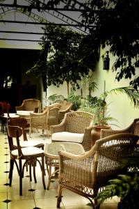 a group of wicker chairs and tables on a patio at Solar De La Plaza in Salta