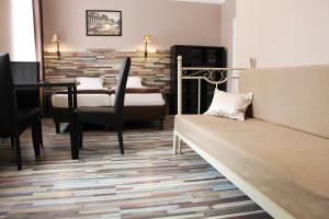 a living room with a couch and a table at Promenade Panzi&oacute; in Miskolc