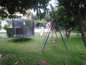 an empty swing set in a yard at GIOTA ROOMS in Arkoudi