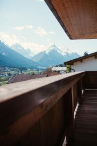 a view of mountains from the balcony of a house at Königin Serles - großzügig, gemütlich & nachhaltig in Fulpmes
