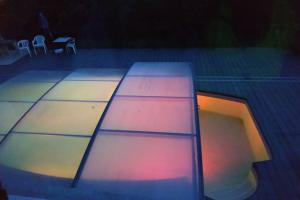 a surfboard sitting on top of a swimming pool at Charme Z'Aisne in Louâtre +7 photos