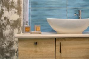 a bathroom with a sink and a bowl on a counter at Aphrodite Mountain View in Périon