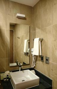 a bathroom with a sink and a mirror at Heaven Hotel in Playa del Carmen