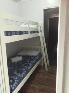 a bedroom with two bunk beds in a room at Oakridge Motel Tourist Park in Oakey
