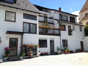 a white house with flowers on the balconies at Landgasthof Löwen in Rottenburg