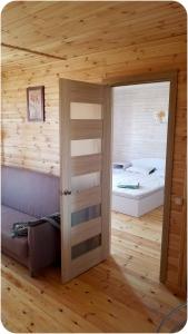 a room with a room with a bed and a door at Удачное место in Rozhny