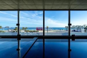 a view of the ocean from a building with a pool at Kensington Resort Seorak Beach in Sokcho