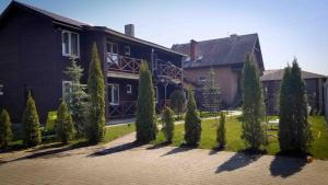 a row of trees in front of a house at Удачное место in Rozhny