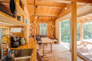 a kitchen and dining area of a tiny house at PACIFICO SURF HOUSE - Mountain in Shishikui
