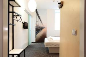 a room with a bed and a view of a bridge at Maverick Budapest Soho in Budapest