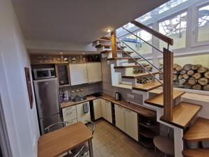 a kitchen with a spiral staircase in a house at Pušynas Apartments in Juodkrantė