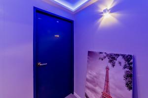 a blue door with a picture of the eiffel tower at Guesthouse Dear Moon in Busan