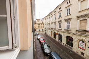 a view from a window of a street with parked cars at Vintage Poselska Apartment in Krakow