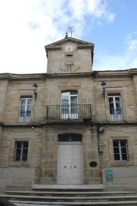 a building with a clock tower on top of it at Casa de la Abuela en el Camino de Santiago a Finiesterre in Negreira