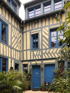 オンフルールにあるReglisse et Pain d'Epices - Chambres d'hôtesの青いドアと窓のある古い家