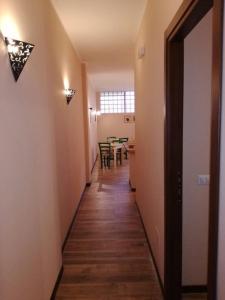 a hallway leading to a dining room with a table at Sleep'n go Hotel in Fiumicino