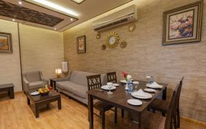 a living room with a table and a couch at Platinum Seventy in Jeddah
