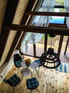 ein Dachzimmer mit einem Tisch, Stühlen und einem Kronleuchter in der Unterkunft Tuvāk dabai in Aglona