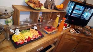 a kitchen counter with a tray of fruits and vegetables at Pension Bergseeblick in Titisee-Neustadt