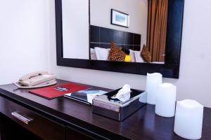 a desk with a mirror and a phone on it at Platinum Seventy in Jeddah