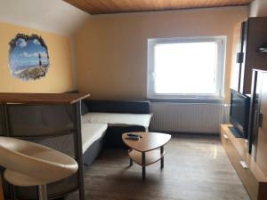 a small room with a bed and a tv at Haus Sonnenschein in Stafstedt