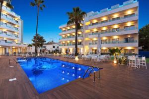 a hotel with a swimming pool in front of a building at Metropolitan Juka Playa in Playa de Palma +27 photos