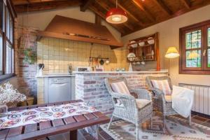 a kitchen with a table and chairs and a counter at El Choco, a small place in paradise. V.V435AS in Parres de Llanes