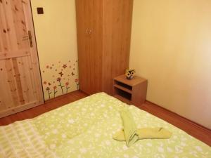 a bedroom with a bed with a pair of shoes on it at CHATA NATAŠA in Dedinky +22 photos