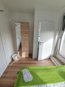 - une chambre avec un lit vert et un couloir dans l'établissement Studiotel Belle Etage, à Düsseldorf