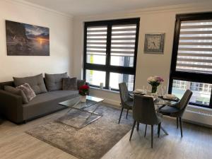 a living room with a couch and a table at Apartament Daria Portova in Gdynia
