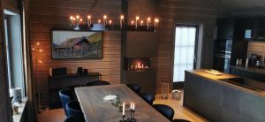 a dining room with a table and a fireplace at Timblalodgen in Sogndal