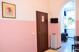 a door in a room with a pink wall at Hotel New Milan in Milan