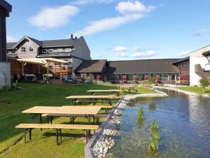 a row of picnic tables next to a river at Rytterlia 6 in Drangedal