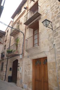 un edificio con 2 balcones, puerta y luz de la calle en Cal Gorro en Arnes