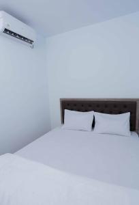 A bed or beds in a room at Amethyst cengkareng syariah